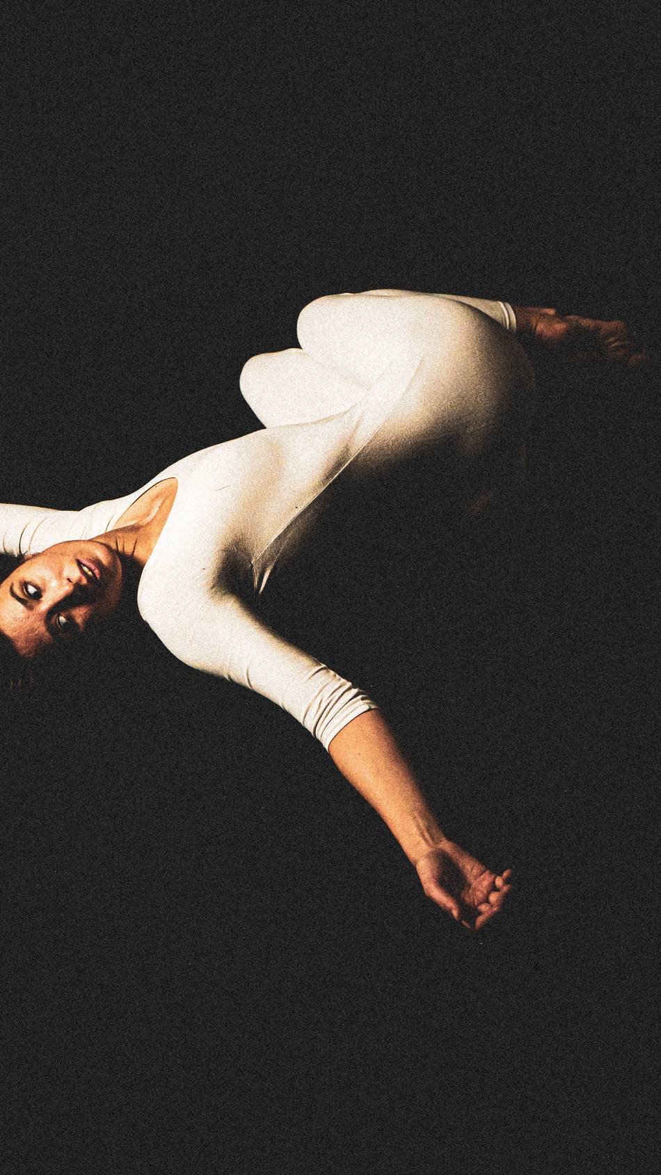 Dancer suspended mid-fall, hair in motion