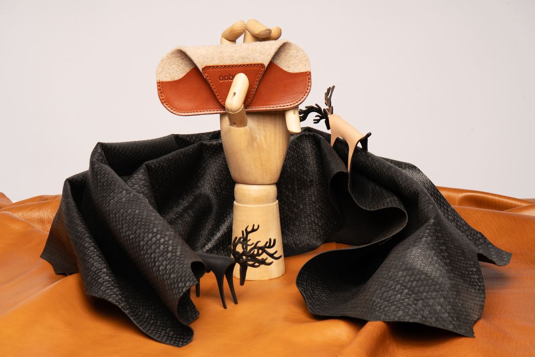 Leather eyewear case on a wooden hand