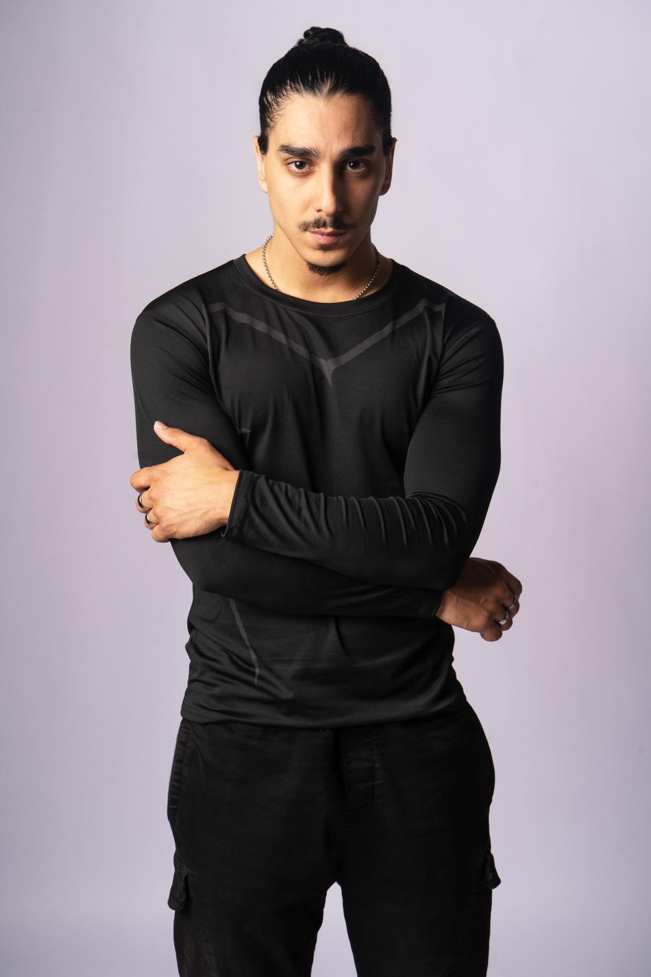 Actor portrait, arms crossed, direct gaze