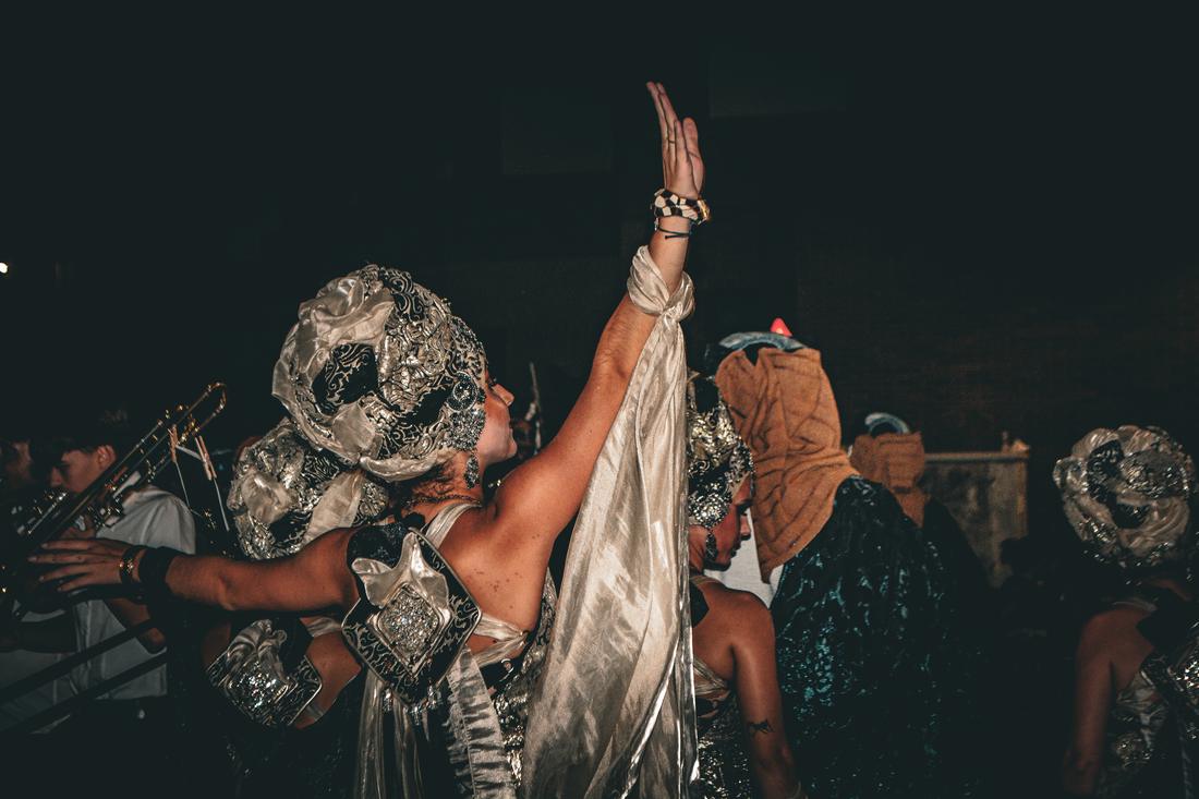 Dancer's arm raised against a dark background