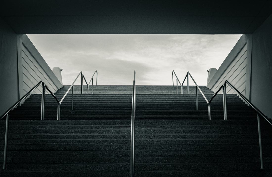 Symmetric stairway rising into an empty sky