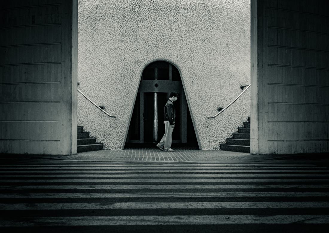 Man walking through a tiled arch entrance